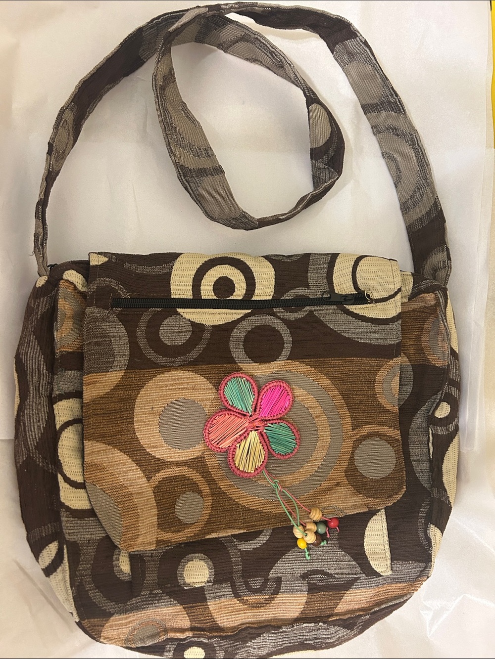 Woven Multi‑Brown Circle Pattern Crossbody Bag with Floral Accent